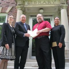 President-elect Mark Hassakis presents the "Papers of Abraham Lincoln" to the Mount Vernon Library. On hand for the event were (left to right): ISBA member and Mt. Vernon attorney Julie Quinn, President-elect Hassakis, library director Bill Pixley, ISBA member and Mt. Vernon attorney Sonja Ligon.