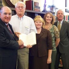 ISBA President-elect Mark D. Hassakis (left) presented The Papers of Abraham Lincoln to the Marion Carnegie Library in Marion on April 13. Accepting the books is library director David Patton (second from left). On hand for the presentation were (beginning 3rd from left) Tambra K. Cain, of the law firm Barrett, Twomey, Broom, Hughes & Hoke LLP, Jackson County Bar Association secretary; Amanda Byassee Gott, president, Williamson County Bar Association (WCBA); and William P. Novick of Marion, an ISBA and WCBA member. 