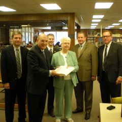 ISBA President-elect Mark Hassakis (second from left) presented the four-volume set to the Mt. Carmel Public Library on March 17 as a gift from the ISBA and its charitable arm, the Illinois Bar Foundation. Accepting the books is library director Louise Taylor.  On hand for the presentation were local attorneys (from left) John P. Farrar, William C. Hudson, George Woodcock Jr., and John E. Rhine.