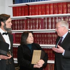 President O'Brien (right) presents the set to Lincoln Library Director Nancy Huntley as Lincoln re-creator Randy Duncan looks on at the ISBA's Illinois Bar Center in Springfield.