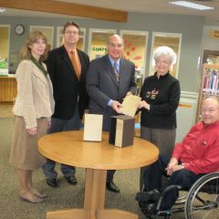 ISBA President-elect Mark Hassakis (center) presented the four-volume set to the Olney Public Library on Feb. 17 as a gift from the ISBA and the Illinois Bar Foundation. Accepting the books is Judy Whitaker (second from right), library director. On hand for the presentation were (from left) Judges Kimbara G. Harrell and Larry D. Dunn, both of the 2nd Judicial Circuit, and Olney attorney Tom Weber.  