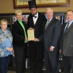 President O'Brien also presented a set of books to a board member of the Prophetstown library, the Henry C. Adams Memorial Library. Accepting the set of books was a board member (at left) Sharon James-Reedy. Also in the photo (from left) Jennifer Slaney, head librarian, Sterling Public Library; Abe Lincoln re-creator, George Buss; John O
