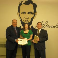 ISBA President-elect Mark Hassakis (at left) presented The Papers of Abraham Lincoln to the Vandalia Public Library on April 5. Accepting the books is Jessica Blain, library director. On hand for the presentation was Vandalia attorney David A. Oldfield, an ISBA member.
