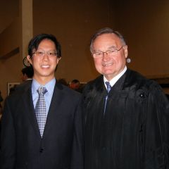 Justice Lloyd A. Karmeier congratulates Andrew Kim of Belleville after he was sworn in on Thursday.