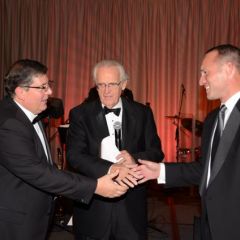 ISBA 3rd Vice President Richard D. Felice accepts the raffle prize from IBF Board member Peter Flowers as M.C. Lester Munson (center) looks on