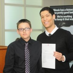 Thomas Roche Jr. receives the Achievement Award from teacher Phillip Rutherford