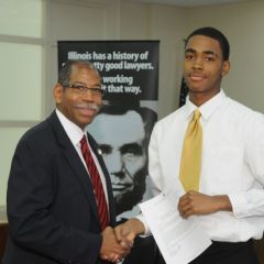 Dean Smith presents a Moot Court Award to Maurice Hunter