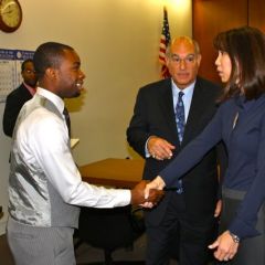 Teacher Tyrese Foreman greets Judge Liu.