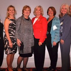 Sandra Crawford (second from right), immediate past Chair of the ISBA Women and the Law Committee, and friends greet Lilly Ledbetter.