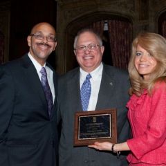 A Chicago Alumni Chapter Centennial Award is presented by Pierre Priestley and Michele Jochner to past Chapter Justice, Benjamin Hyink