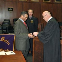Appellate Court Justice Nathaniel R. Howse, Jr. receives his fraternity pin from Chicago Alumni Chapter Honorary Justice James F. Holderman, Chief Judge of the U.S. District Court, as PAD District XI Justice John K. Norris looks on.  