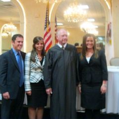 New admittees Arynn Wassel and Ryne Takacs, Chief Justice Thomas L. Kilbride and new admittee Allison VanNatta.
