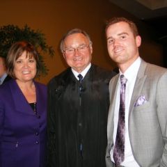 Supreme Court Justice Lloyd Karmeier congratulates new admittee Bryce Joiner and his mother Barbara.