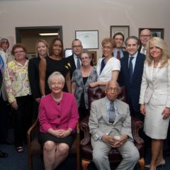 Judge Leighton is surrounded by members of the event Steering Committee.