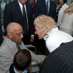 Illinois Supreme Court Justice Anne. M. Burke congratulates Judge Leighton and presents him with a copy of his oath to become a member of the Illinois bar, which he took in 1947.