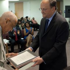 Jeffrey D. Colman, Partner at Jenner & Block and Vice-Chair of the event Steering Committee, presents Judge Leighton with a congratulatory letter from U.S. President Barack Obama.