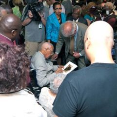 Judge Leighton is surrounded by well-wishers and media after the event.