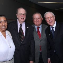 Prof. Cliff Scott-Rudnick of The John Marshall Law School is greeted by Chicago Alumni Chapter Board members Julie-April Montgomery, Hon. Russell Hartigan, and John O'Brien.