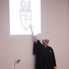 Leah Farmer, Justice of the Story Chapter at DePaul University College of Law, explains the symbols in the fraternity's coat of arms.