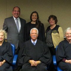 New admittee Kristin Creed and family with Justices Burke, Freeman and Theis.