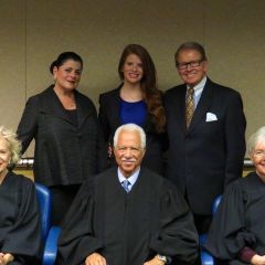 New admittee Grace Donovan (rear, center) and her family pose with Justices Anne Burke, Charles Freeman and Mary Jane Theis.