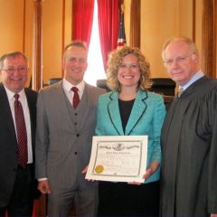 Father and ISBA member Randy Chaplinski, husband Mike Saineghi, new admittee L. Claire Chaplinski and Chief Justice Thomas L. Kilbride.