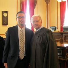 New admittee Zach Milus and Chief Justice Thomas L. Kilbride.
