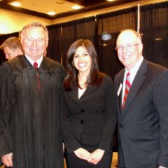 New admittee Juliane Rodriguez is congratulated by Illinois Supreme Court Justice Lloyd A. Karmeier and ISBA President John E. Thies.