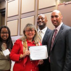 Event co-chairs Kenya Jenkins-Wright (left) and David Kadzai (second from right) and CCBA President John A. Fairman present ISBA President-elect Paula H. Holderman with a certificate honoring the ISBA for its sponsorship of the Law Day luncheon.