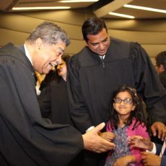 Chief Cook County Circuit Court Judge Timothy C. Evans greets Armaan, 9, as his sister, 5-year-old Sarina, and his father, Judge Mohammed M. Ghouse look on. Judge Ghouse was one of 13 associate judges sworn in Monday, May 9, 2016, at an event held in the James R. Thompson Center.
