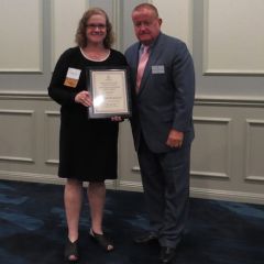 Kathryn Kelly, Austin Fleming Newsletter Editor Award recipient, and&nbsp;President Russell Hartigan
