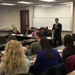 Moderator Mike Alkaraki and panelists speak to an audience of law students at&nbsp;ISBA Day at Loyola University Chicago School of Law.
