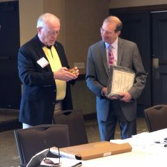 The Environmental Law Section Council's incoming chair Phil Van Ness presents a plaque to outgoing chair Kenneth Anspach. 