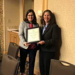 The Health Care Section Council's incoming chair Meghan O'Brien presents a plaque to ex-officio Janet Lerman. 