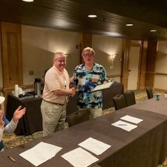 ISBA past president Russell Hartigan presents a plaque to the Tort Law Section Council's ex-officio Judge Tom Lyons. 