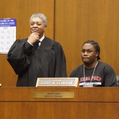 Timothy C. Evans, Chief Judge of the Circuit Court of Cook County, with a student on the bench. 