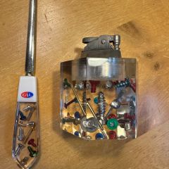 Christopher Barth: "My prized possession is a letter opener and cigarette lighter I inherited from my father, Robert. My dad was hired as an industrial engineer at Great Lake Screw Company who, as the name indicates, manufactured screws, bolts, nuts, etc. The Company gave my father these items when he was hired. As shown in the picture, the letter opener and lighter are made of a clear, Lucite material and have embedded in them screws, nuts, and bolts of many different colors. While the company closed many years ago, these items are an important reminder to me of my dad and, as a kid, held my fascination on many occasions as I marveled at how they made such each item."