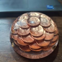 Michael Brandt: "Glass paperweight with pennies encased. A gift from my daughter years ago. All the pennies are the year 1989."