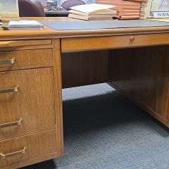 Jennifer Kincaid: "My prized possession isn't on my desk; it is my desk. My grandfather bought the desk in 1965, made by the Leopold Company in Burlington, IA. It came with him to his new venture in Arlington, IA, in the 70s and he sat at it until his retirement in the 80s when it became my father's desk. He gifted it to me in 2013 after I became a partner at my firm. I think the legacy of my grandfather and my father and all the hard work that has been done at this desk for over 60 years."