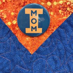 Debra Walker: "This button adorns my orange and blue quilt hanging on my chambers wall behind my desk. It is a vintage button I bought for my now deceased mother on Mom’s Weekend 1981 at University of Illinois, Urbana Champaign. My mother was an Illini Mom x4! Life comes full circle—I recently served as President of the Illini Moms Association. As a double Illini and an Illini Mom, this is a much-prized possession."