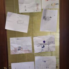 Hannah Wince: "My most prized possession in my office is the ever-changing art installation on my office door. It features artwork by my kids, Lily (8) and Isaac (6). Right now it mostly features portraits of our office cat, Willow, who is very popular with kids and clients."