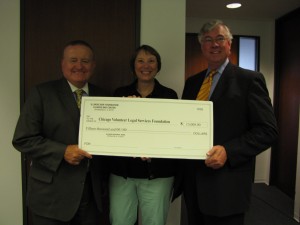 IBF Board members Russell Hartigan (left) of Chicago and George Mahoney (right) of Joliet present a $15,000 grant to Meg Benson, CVLS Executive Director.