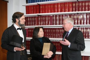 ISBA Presiden John O'Brien (right) presents "The Papers of Abraham Lincoln" to Lincoln Library Director Nancy Huntley as Lincoln re-creator Randy Duncan looks on.